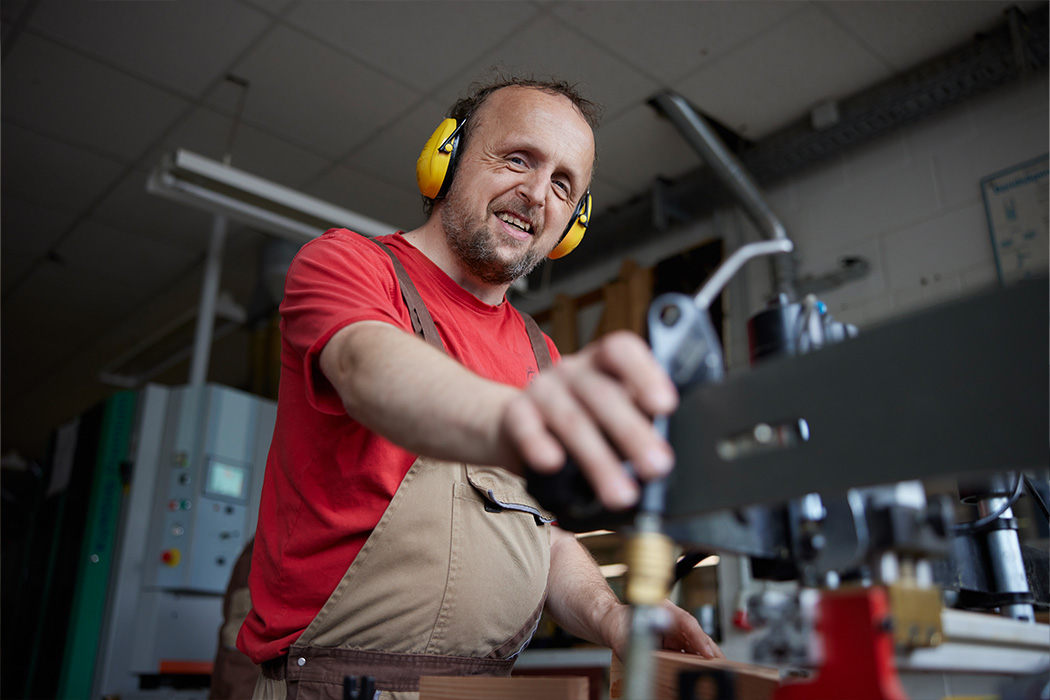 Ein Mann arbeitet in einer Werkstatt an einer Maschine